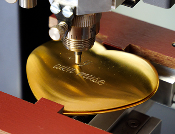 Rotary engraver for gift engraving, small signage and retail personalization.